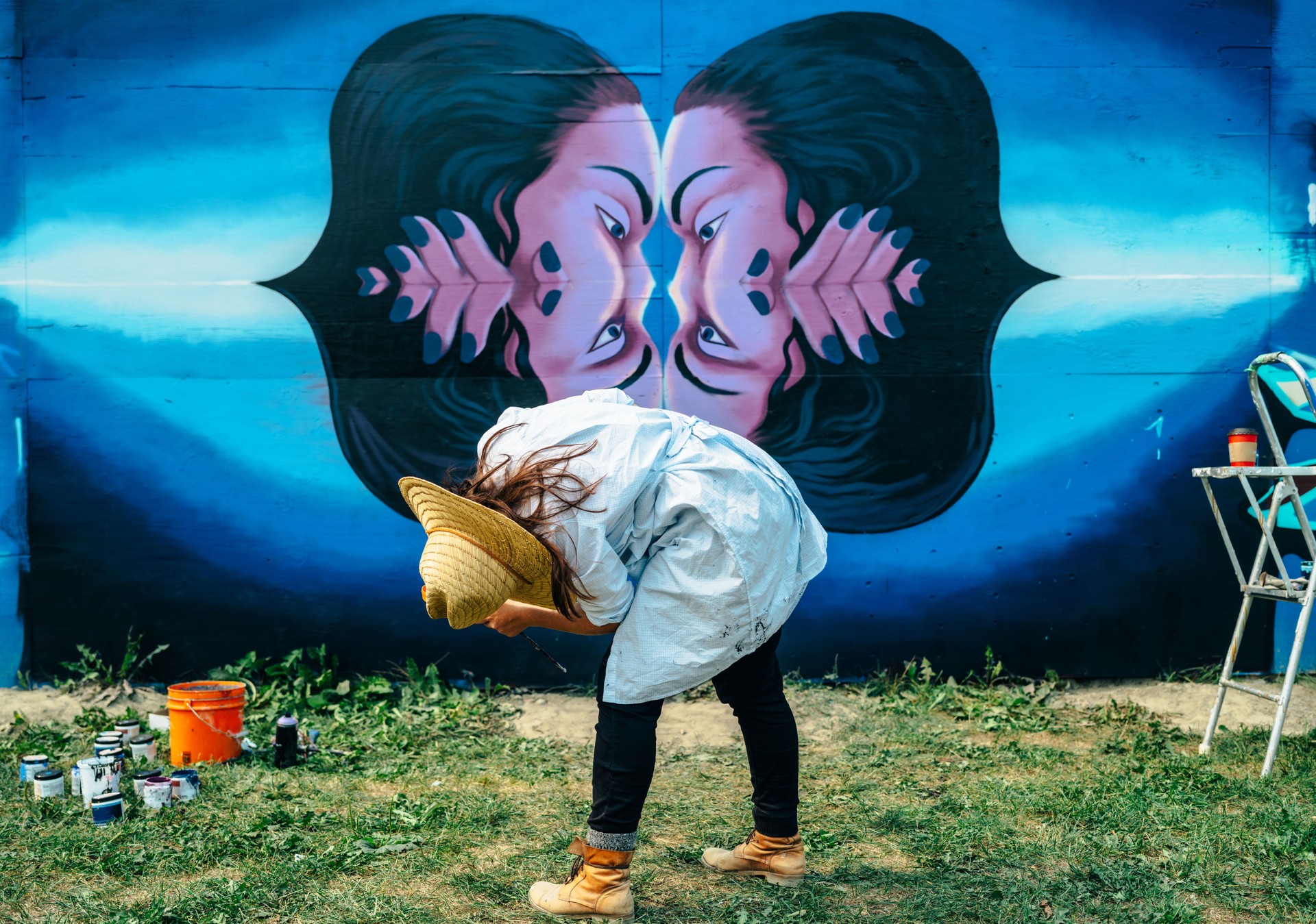 Female mural artist at work